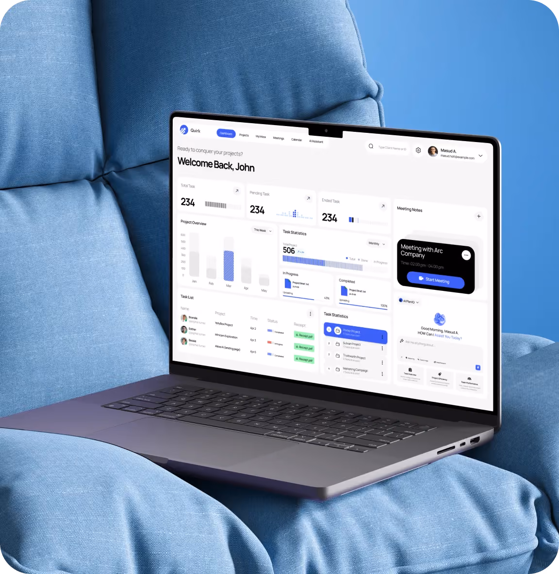Laptop on blue cushioned chair displaying a project management dashboard with stats and meeting info.