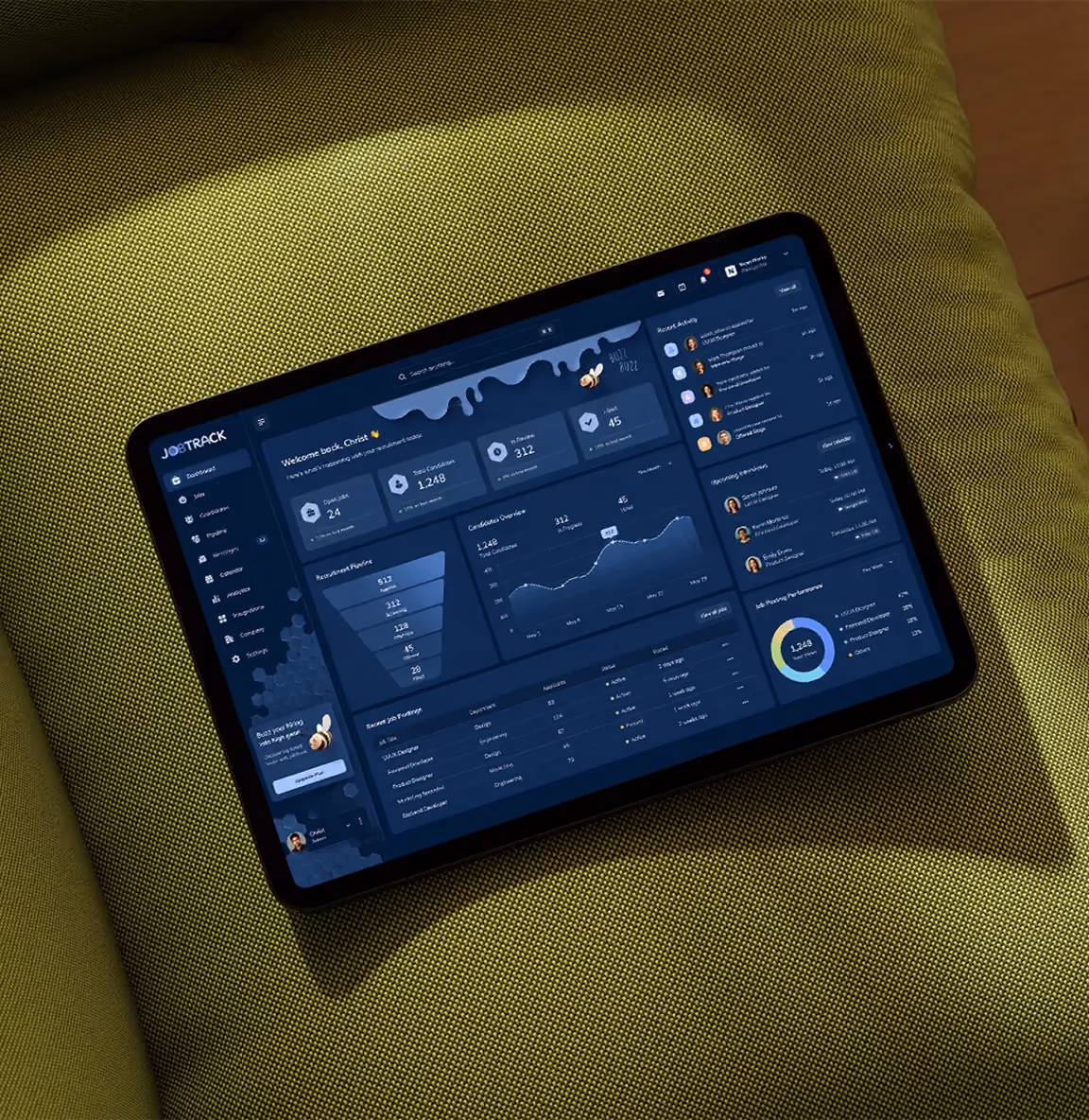 Tablet displaying a dark-themed job tracking dashboard with charts, stats, and recent activity.