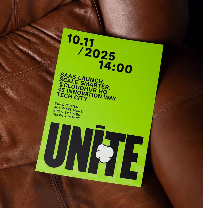Green flyer on brown leather reading SaaS launch event details for Nov 10, 2025, 14:00 at CloudHub HQ.