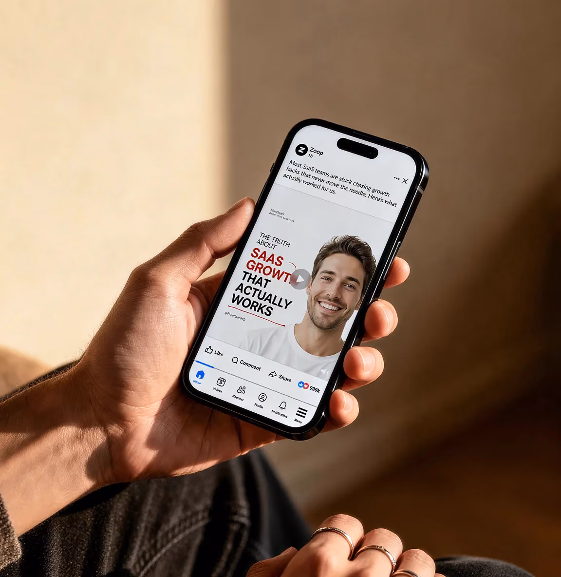Hand holding smartphone showing a social media post about SaaS growth that actually works.
