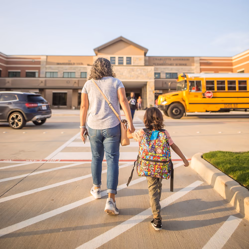Mom and daughter walking into a Plano TX school