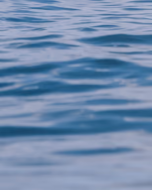 Close-up view of gentle ripples on a calm blue water surface.