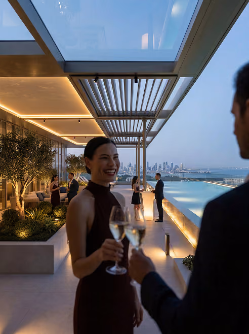 People in elegant attire enjoying drinks at a modern rooftop pool with city skyline at dusk.