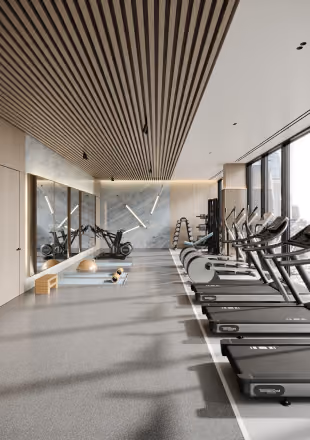 Modern gym with treadmills, stationary bikes, weights, and large windows letting in natural light.