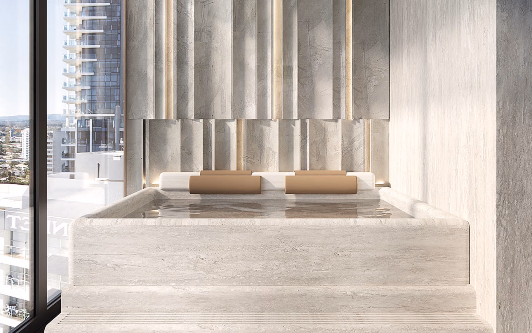 Modern stone plunge pool with beige headrests in bright room next to large window overlooking city.
