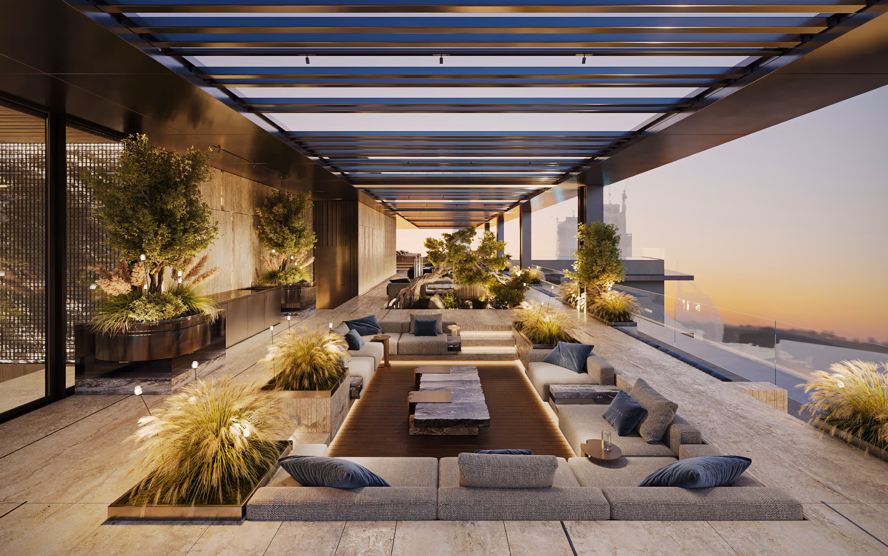 Modern rooftop lounge with sunken seating, stone tables, plants, and glass roof at sunset.