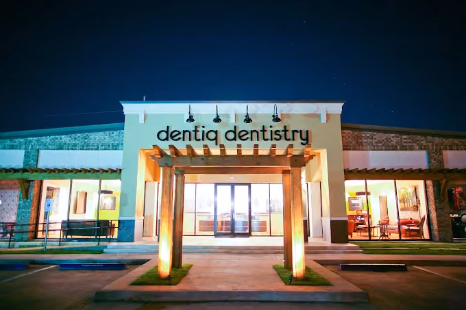 Dentiq Dentistry office exterior at night in Houston, TX