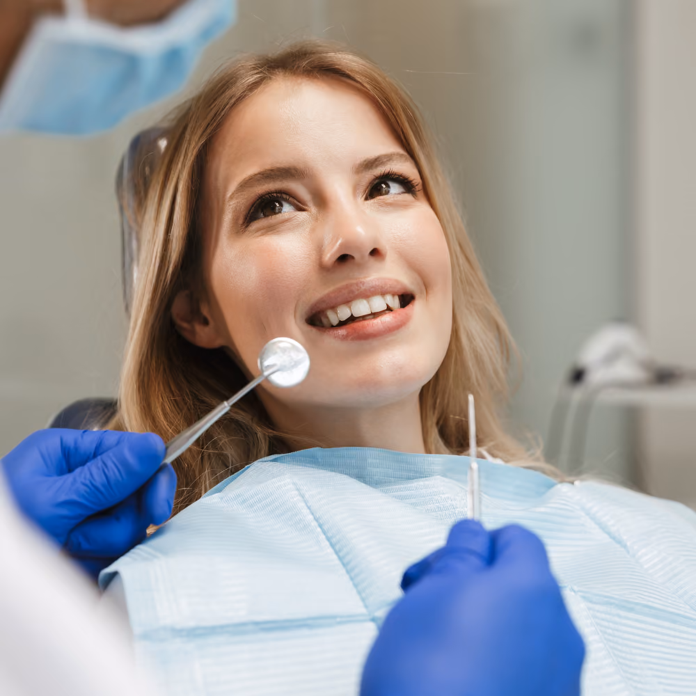 Dentist examining a patient's teeth during a first visit at Dentiq Dentistry