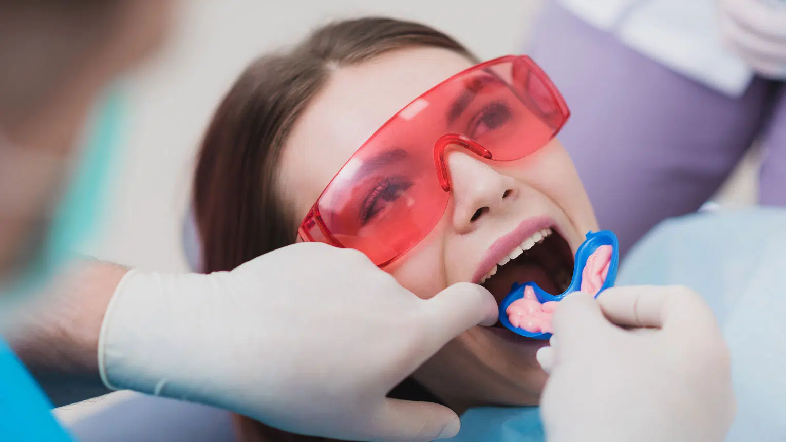 Child receiving a fluoride treatment at Dentiq Dentistry in Houston, TX