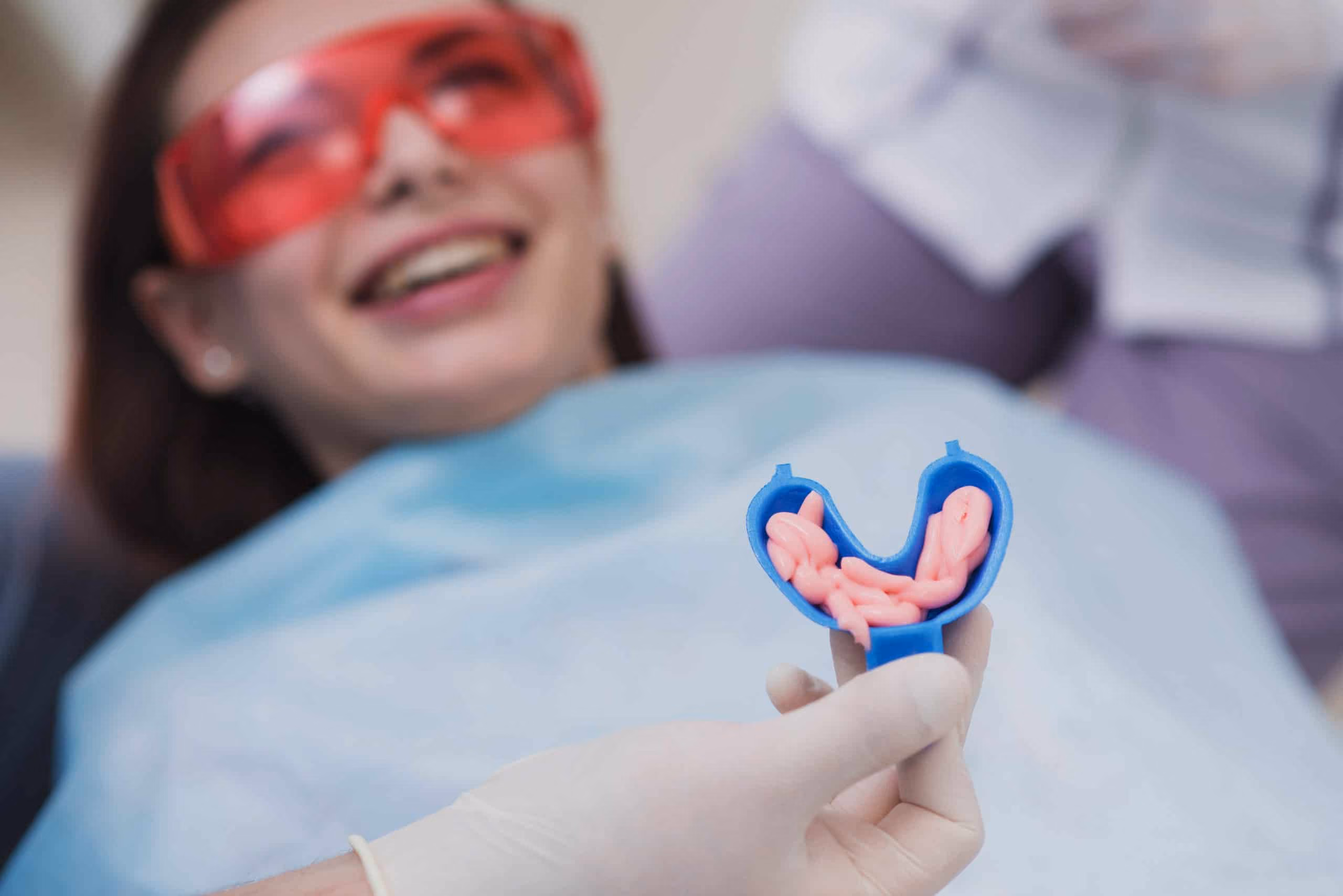 Fluoride varnish being applied to strengthen enamel after a dental cleaning