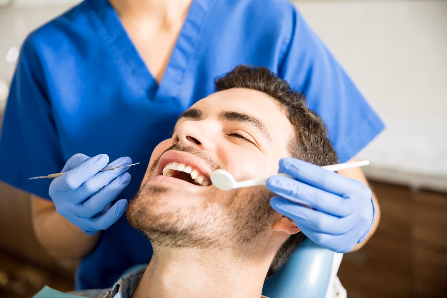 Dental hygienist removing tartar buildup during a professional teeth cleaning