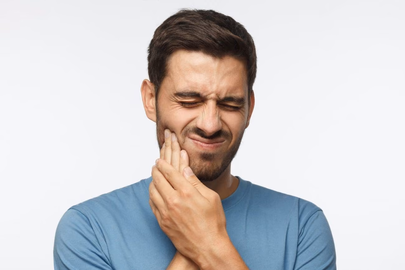 Patient with jaw tension being evaluated for TMJ therapy at Dentiq Dentistry Houston