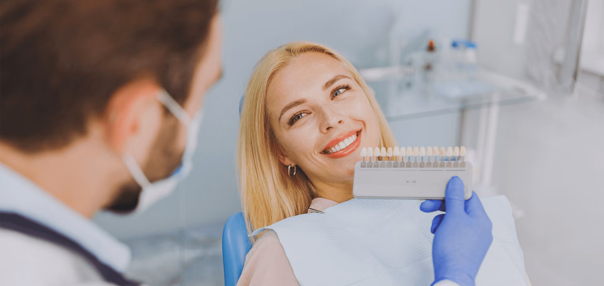 Patient smiling after a porcelain veneers package at Dentiq Dentistry in Houston, TX