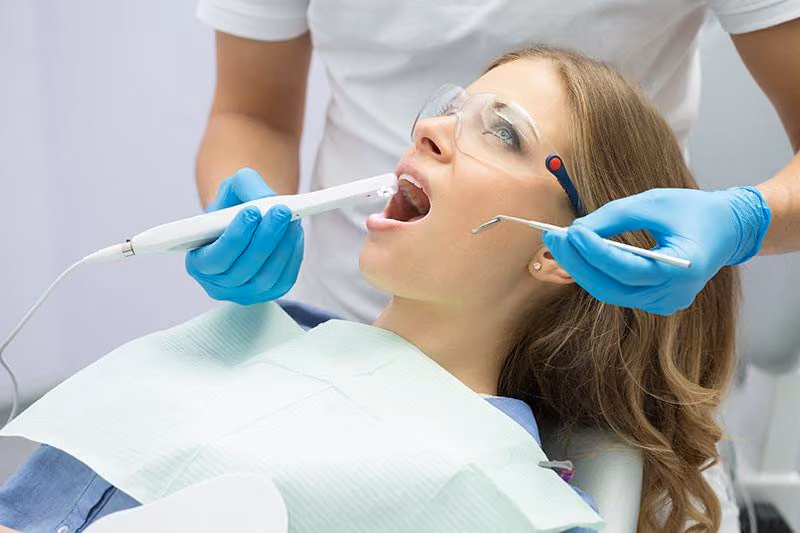 Magnified intra-oral camera image of a tooth shown on a screen in Houston