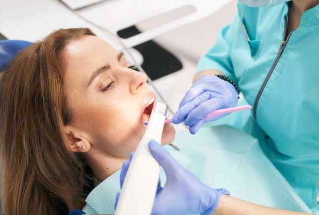 Patient watching intra-oral camera findings on screen at Dentiq Dentistry Houston