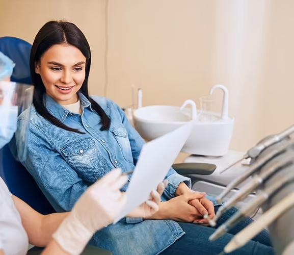 Dentiq Dentistry insurance coordinator helping a patient understand Guardian dental benefits in Houston, TX