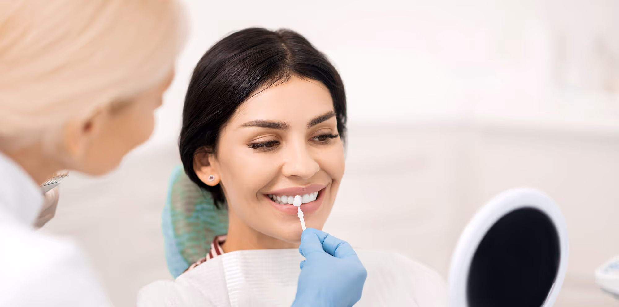 Patient smiling after porcelain veneers treatment at Dentiq Dentistry in Houston, TX