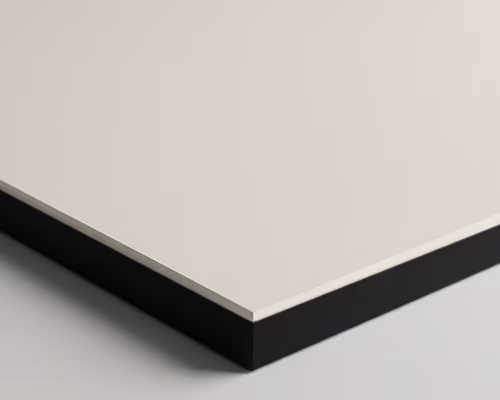 Close-up of a smooth, beige porcelain surface tile with a black edge on a gray background.