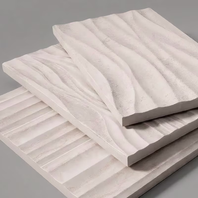 Three stacked square porcelain tiles with textured surfaces featuring different wavy and ridged patterns in a soft white color.