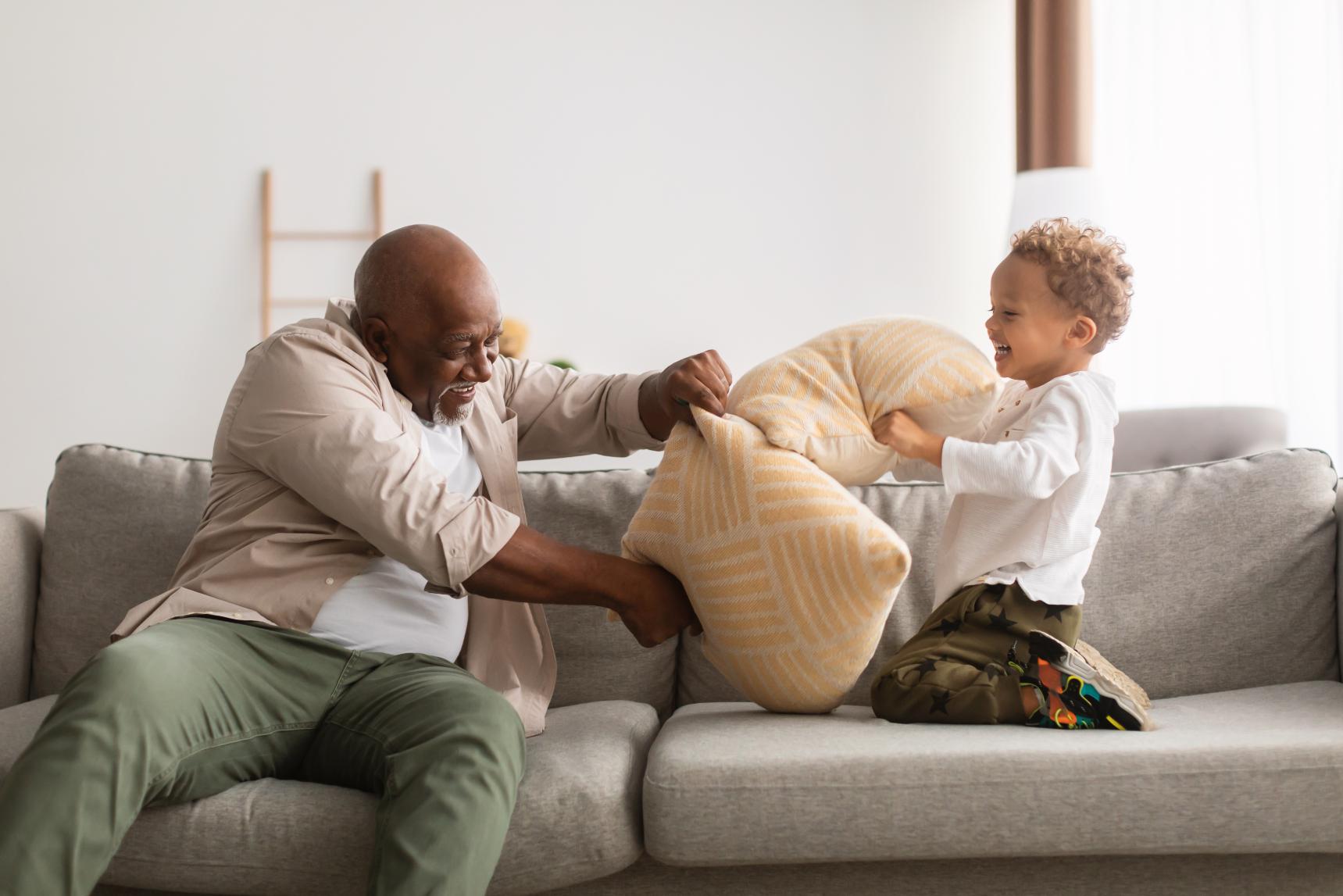 Senior and child on sofa stock image