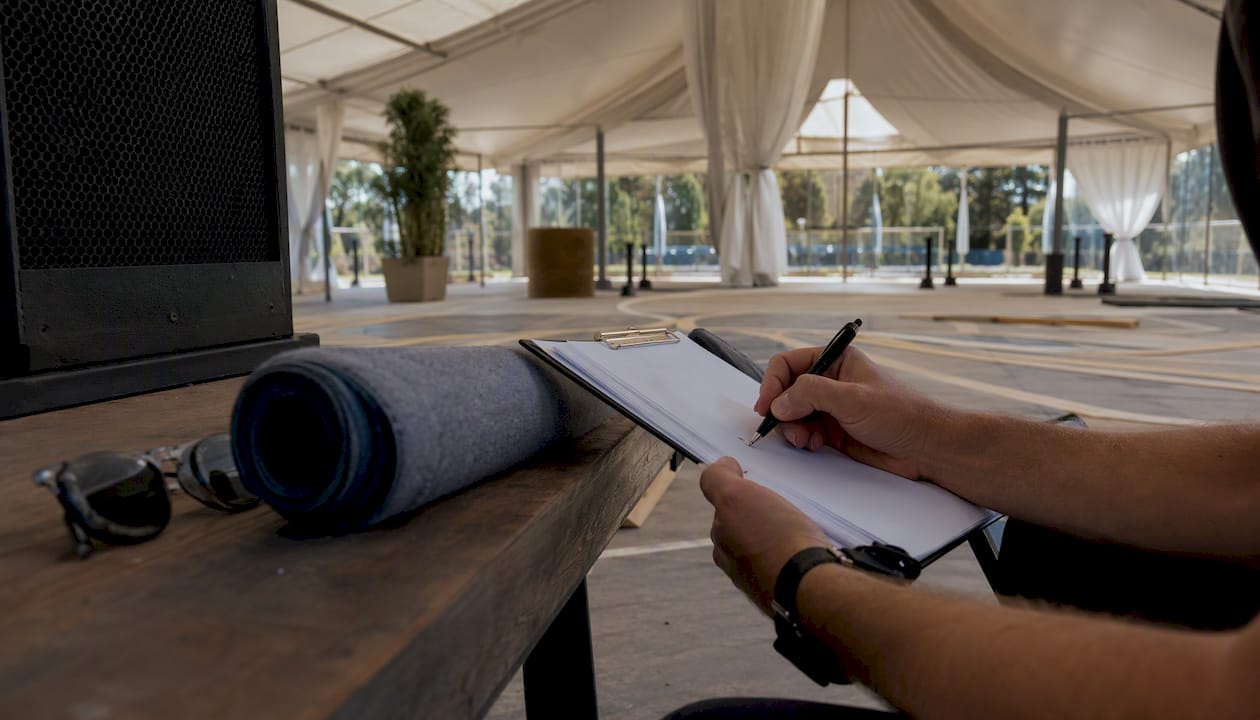 Hands marking checklist during venue walkthrough