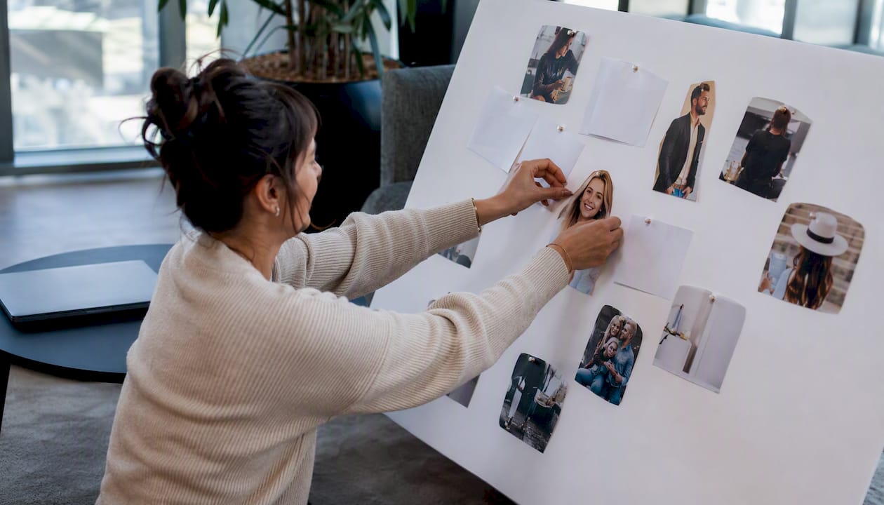 Hands arranging a hotel guest persona board