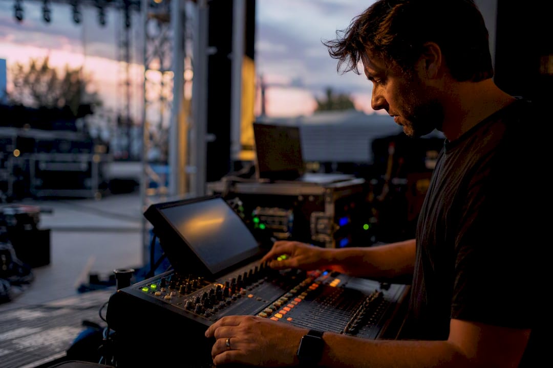 Event producer comparing music set list and audio mixer