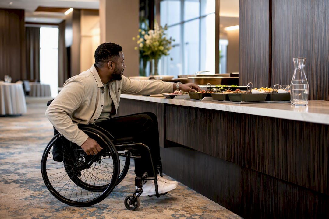 Wheelchair user approaching accessible buffet counter