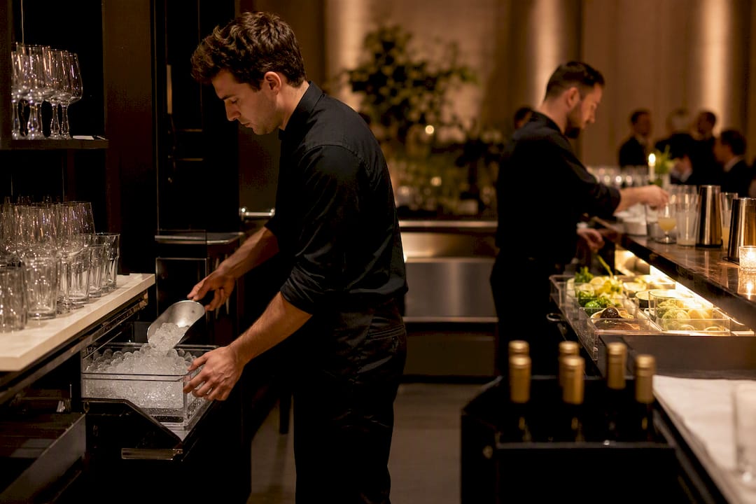 Barback restocking an event service station