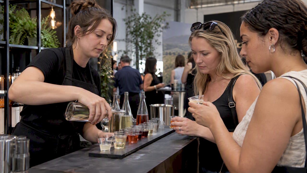 Visitors sampling products at pop-up bar