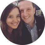 Smiling man and woman posing closely for a photo together.
