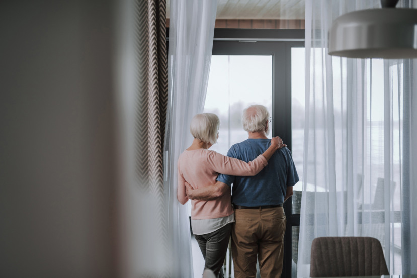 Senior couple embracing on a balcony, representing Vitacon's new senior living development in Sao Paulo