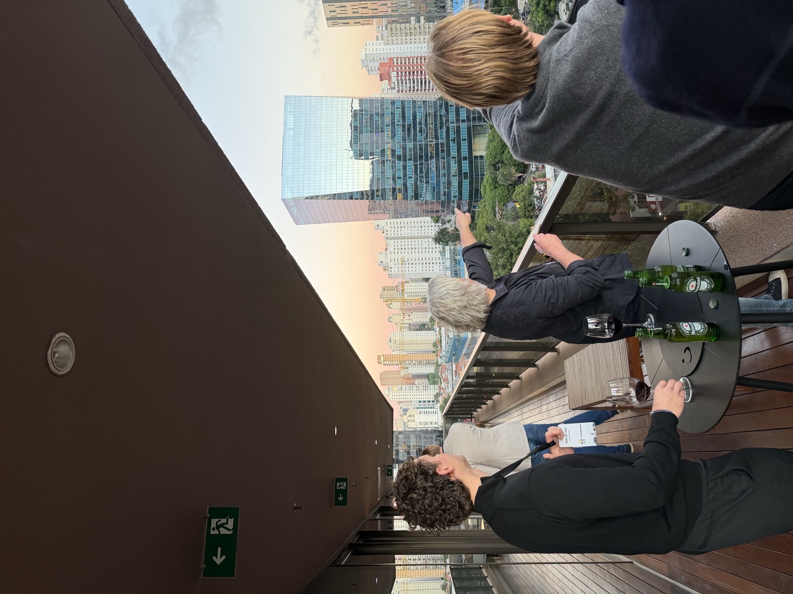 ARD Capital Partners team networking on a Sao Paulo rooftop terrace at sunset