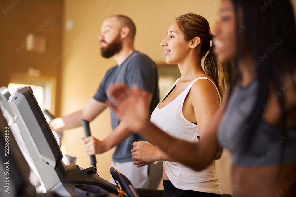 People running on treadmill stock image