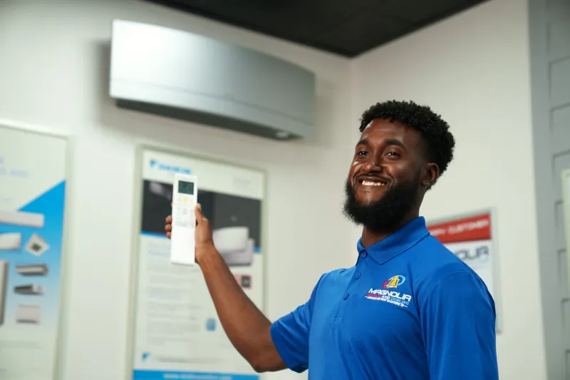 A tech showing a ductless minisplit in a showroom.