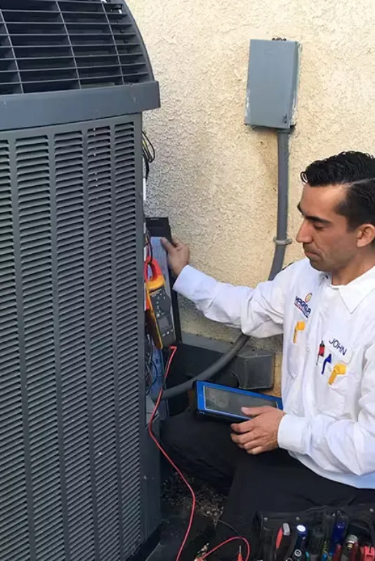 A tech checking an AC unit