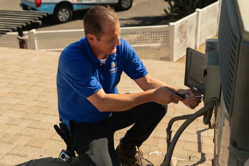 A tech working on a roof.