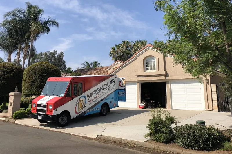 A Magnolia truck at a house.