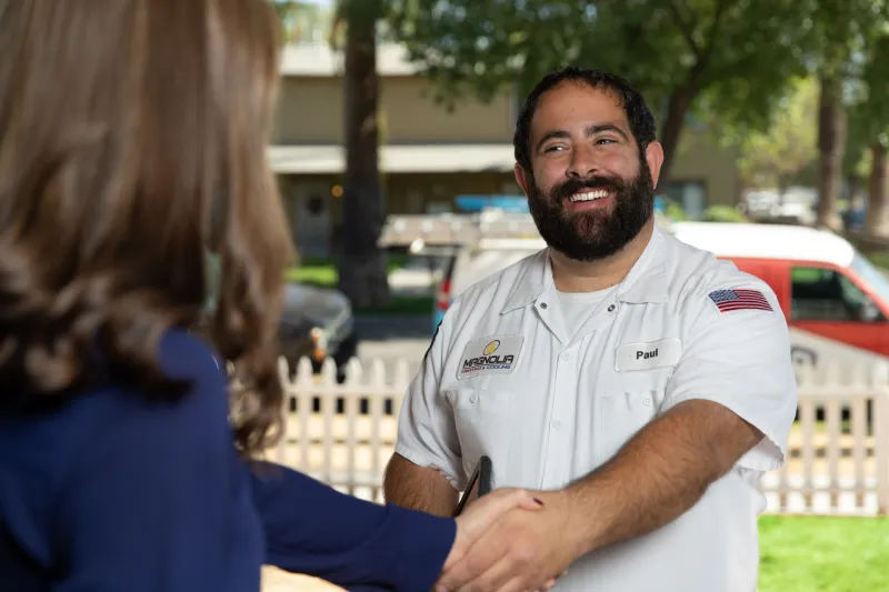 A tech being greeted by a customer.
