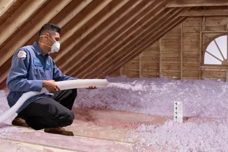 An attic being filled with insulation