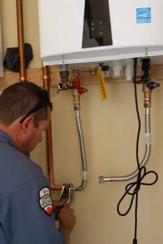 A tech working on a tankless water heater.