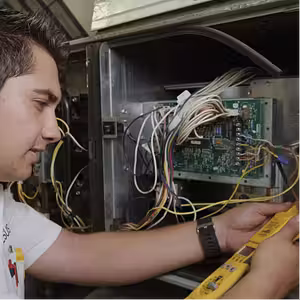 A tech checking an HVAC unit.