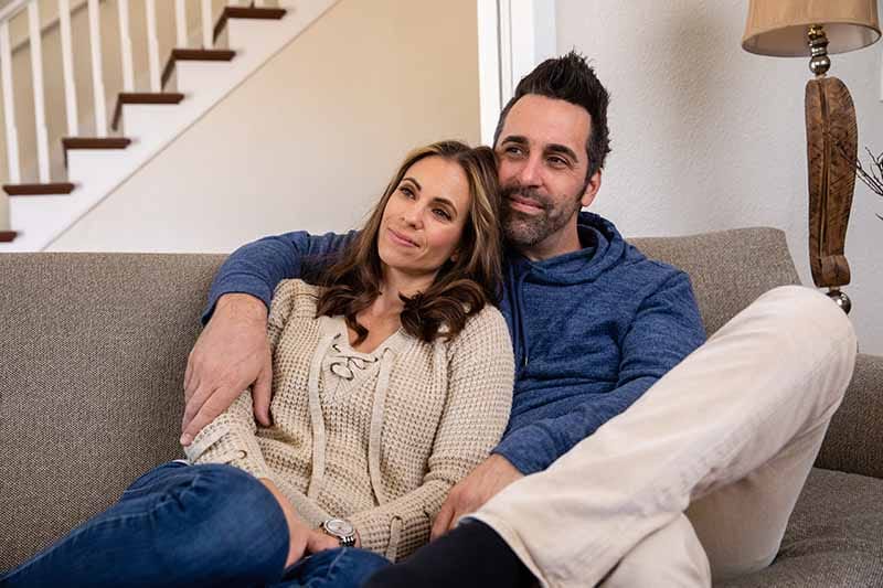 A couple relaxing in their house.