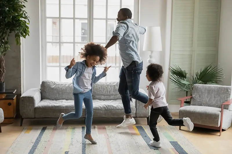 A happy family dancing because their air is clean.