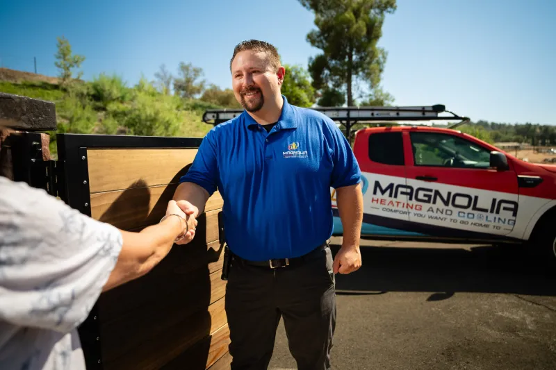 A tech shaking a customer's hand
