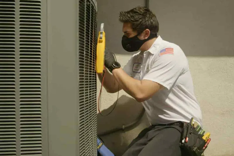 A tech working on an AC unit