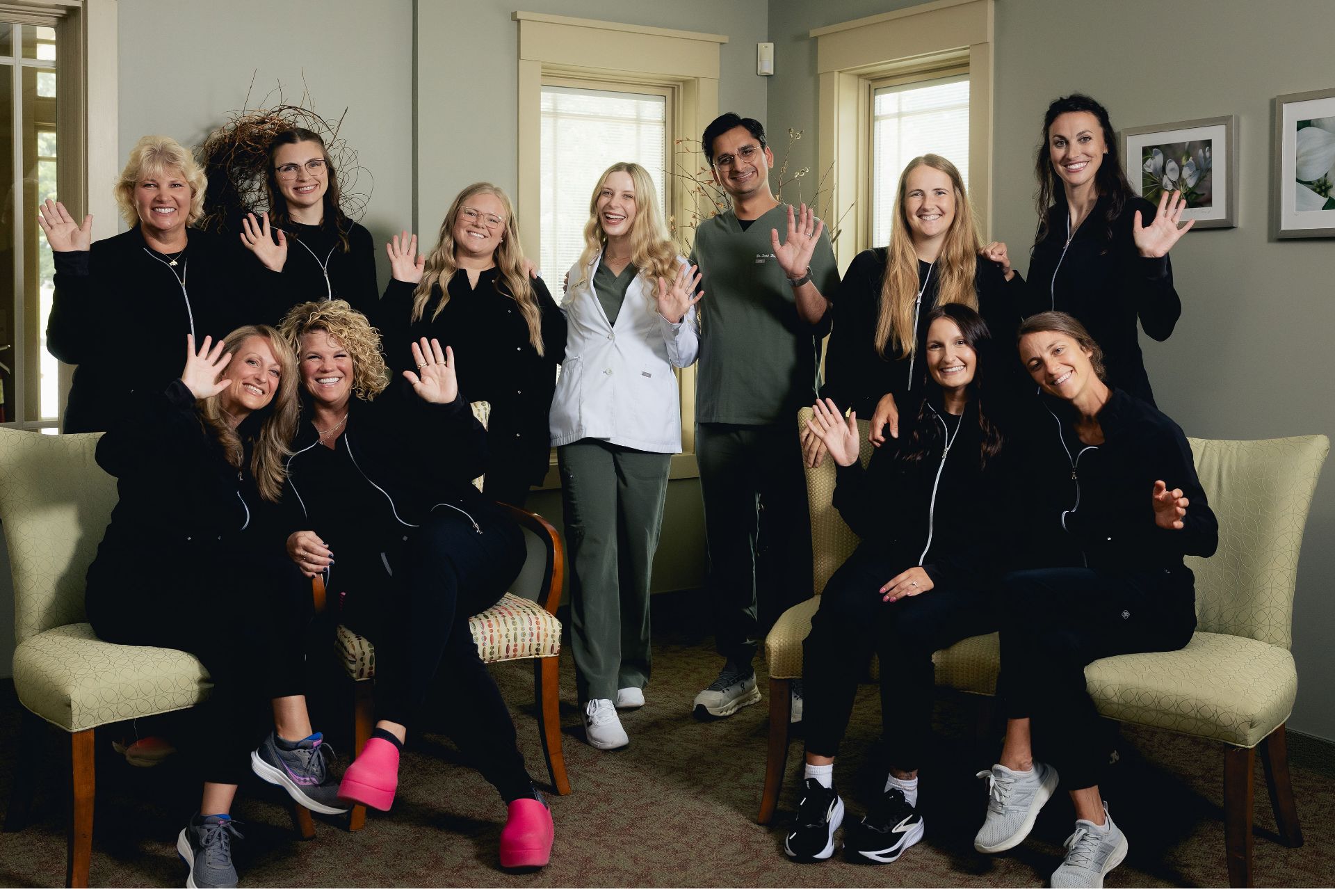 Westfield Center Dental Care team waving together in the office waiting room