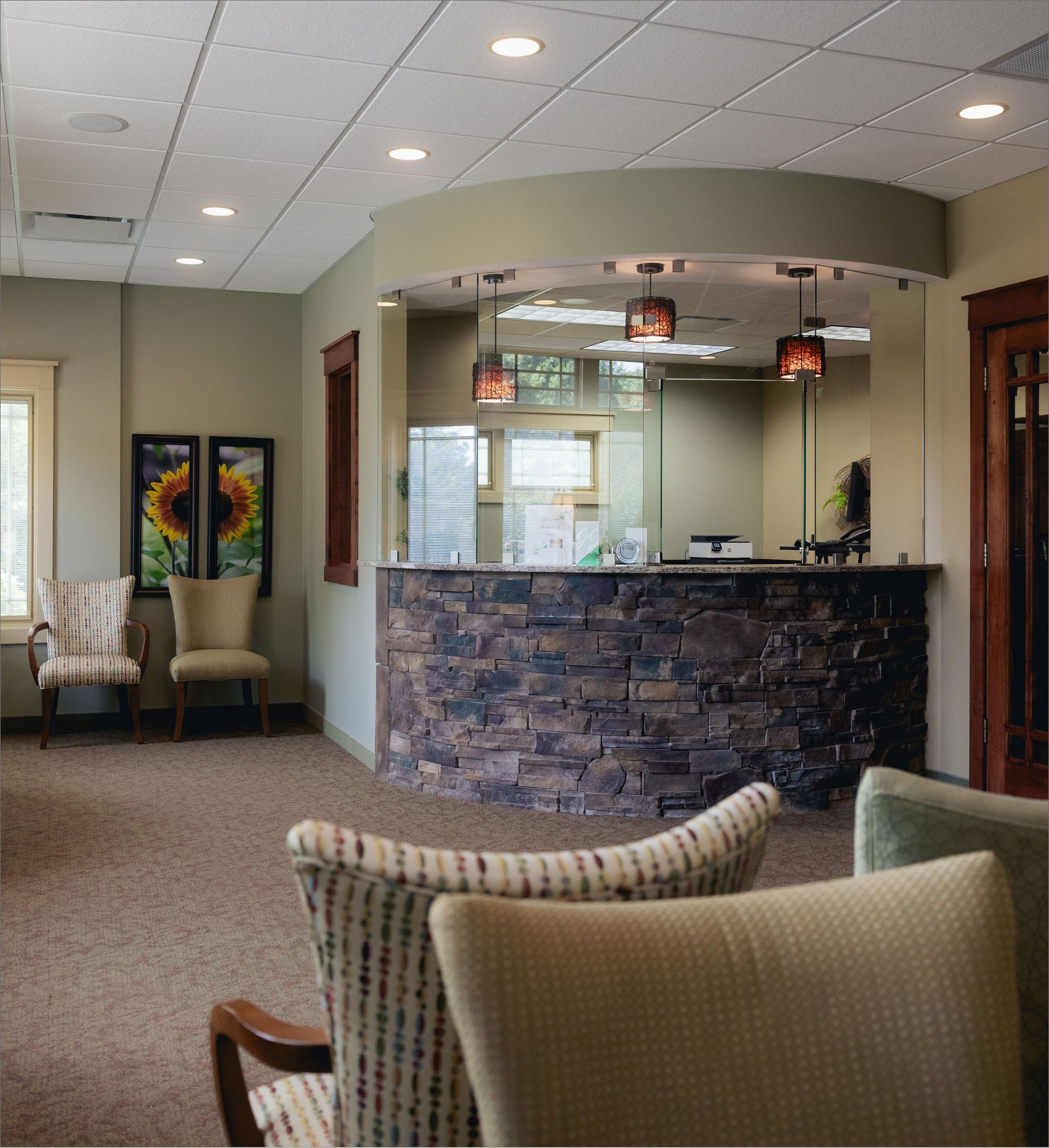 Welcoming waiting room and stone front desk at Westfield Center Dental Care