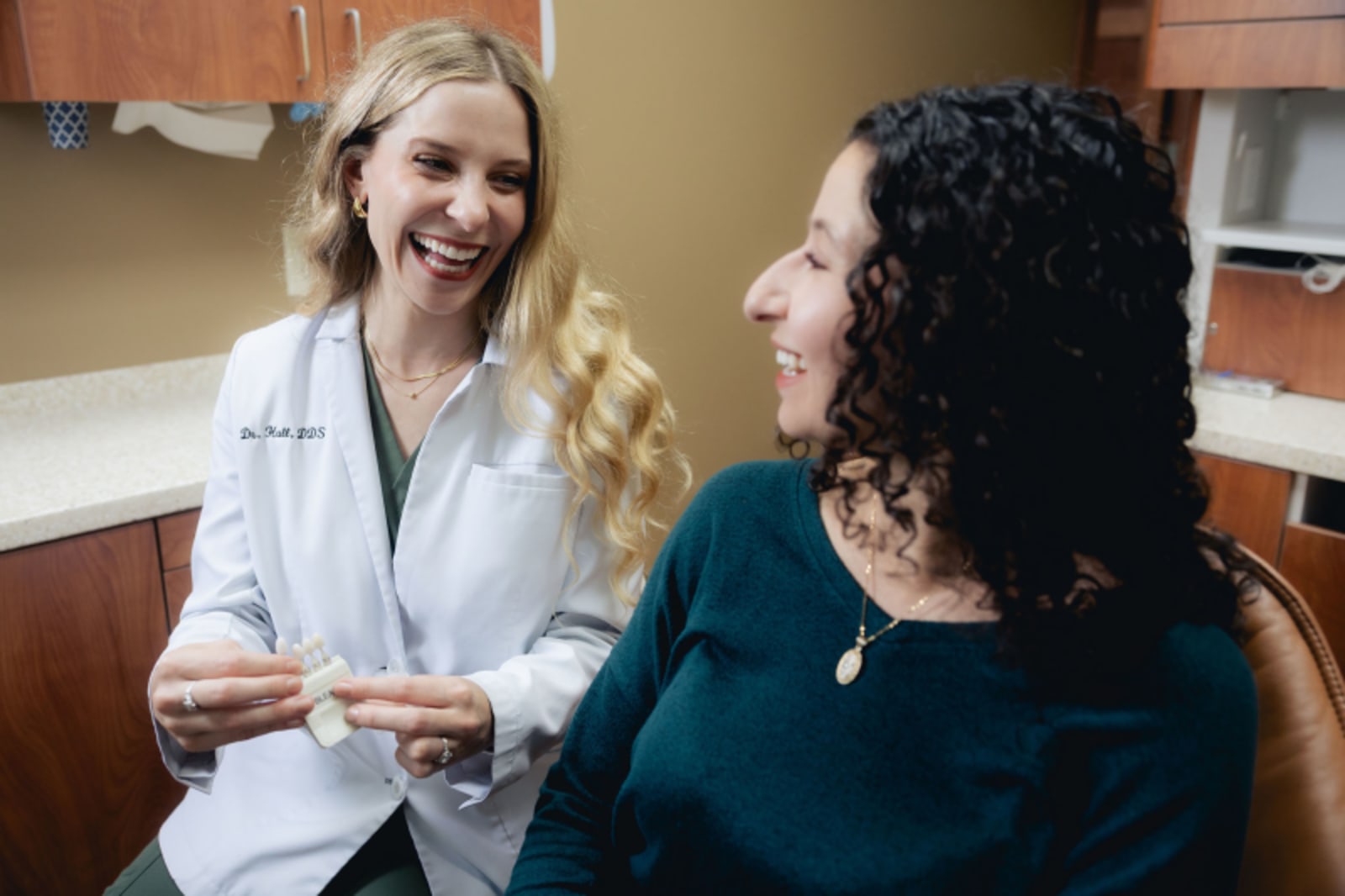 Female dentist discussing treatment plan with patient in consultation setting
