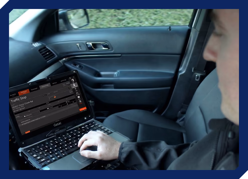 Police officer using the 10-8 Systems CAD platform on a computer